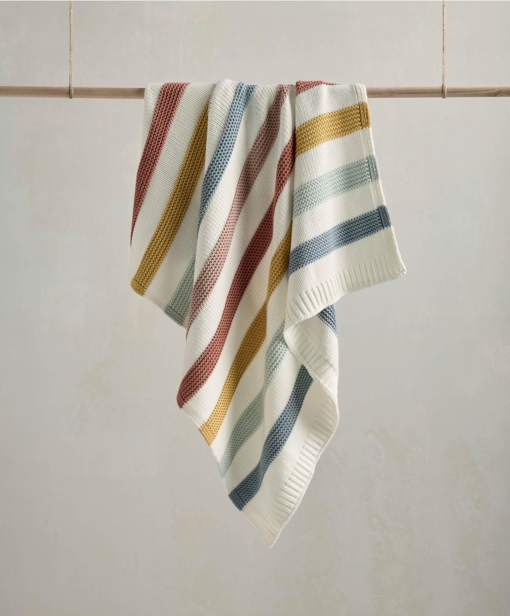 Knitted striped blanket, cream with blue, mustard, green, and red stripes