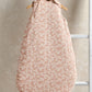 Peach floral sleeveless baby sleep bag with round neckline, armholes, and long bag shape