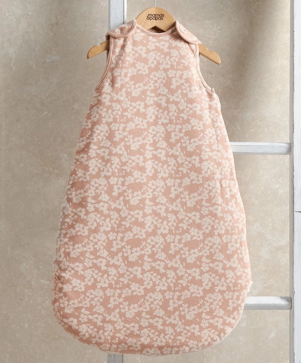 Peach floral sleeveless baby sleep bag with round neckline, armholes, and long bag shape