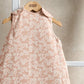 Peach floral sleeveless baby sleep bag with button strap shoulders and pale pink trim