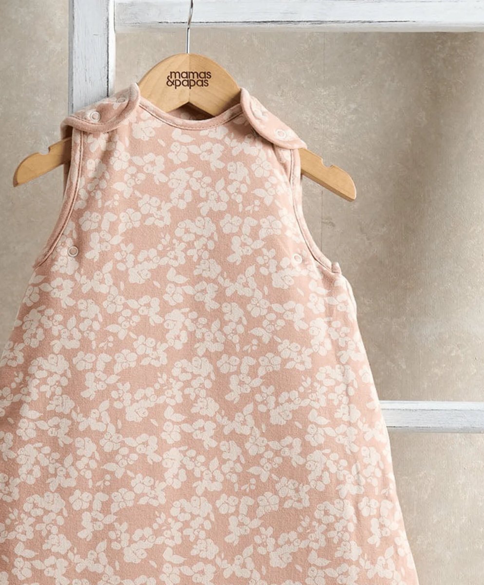 Peach floral sleeveless baby sleep bag with button strap shoulders and pale pink trim