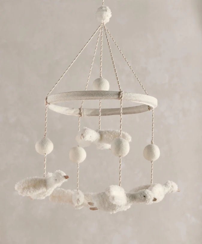 Plush baby musical mobile with white duck figures and hanging pom-pom balls
