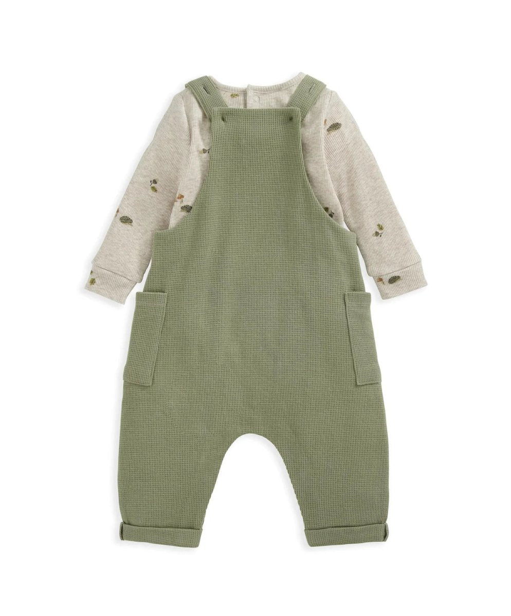 Green dungarees over speckled long-sleeve bodysuit, front pockets and snap straps