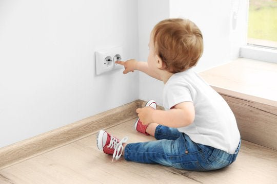 Outlet safety cover with rotating shutter, white, installed on wall