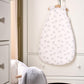Elephant-printed baby sleep sack, white with light gray elephants, front view on hanger