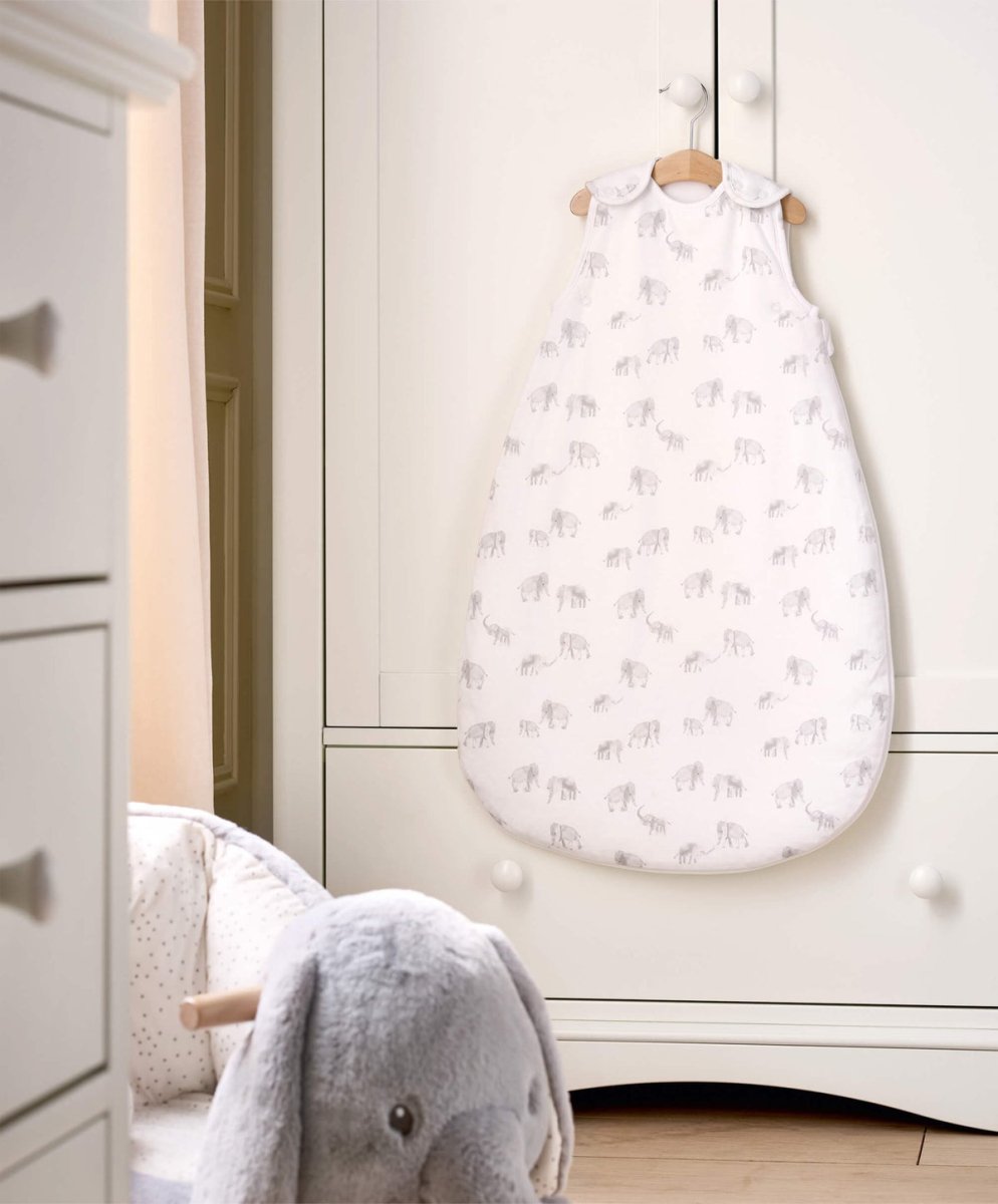 Elephant-printed baby sleep sack, white with light gray elephants, front view on hanger