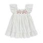 White dress with floral embroidered bodice, gathered waist, and puff sleeves