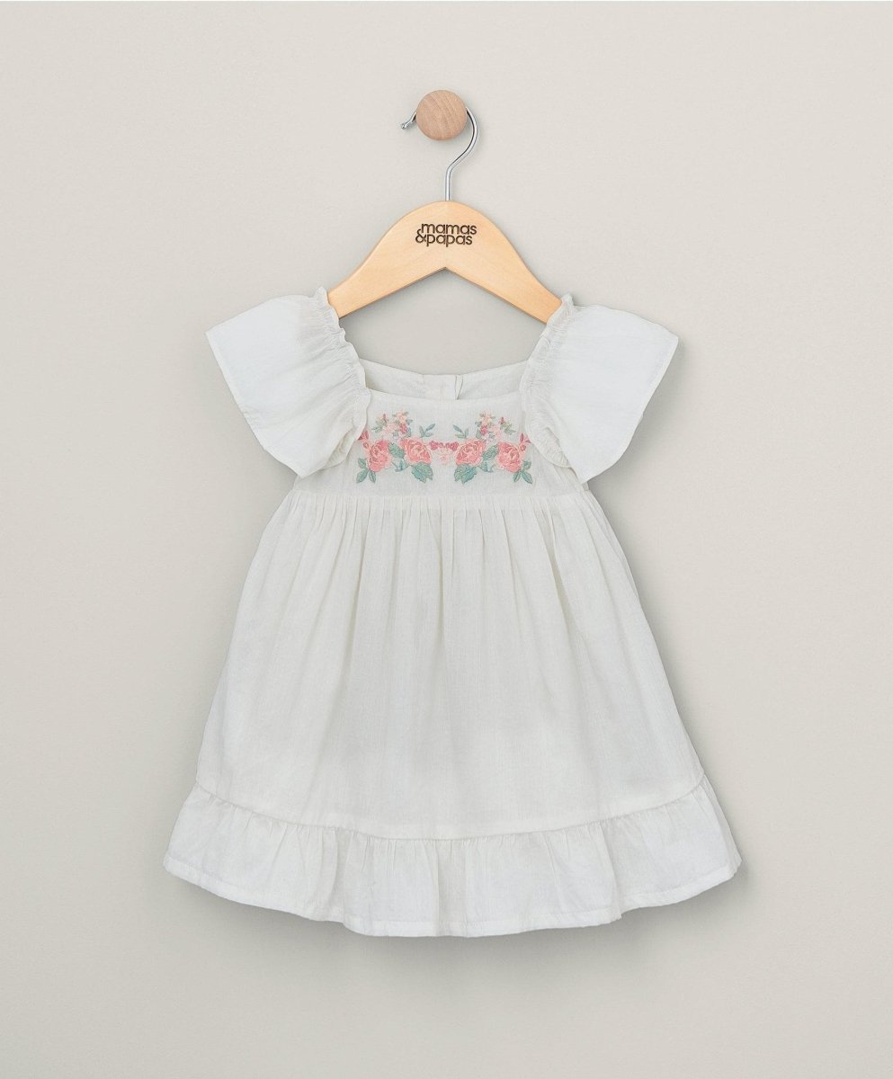 White embroidered flower dress with puff sleeves and tiered skirt