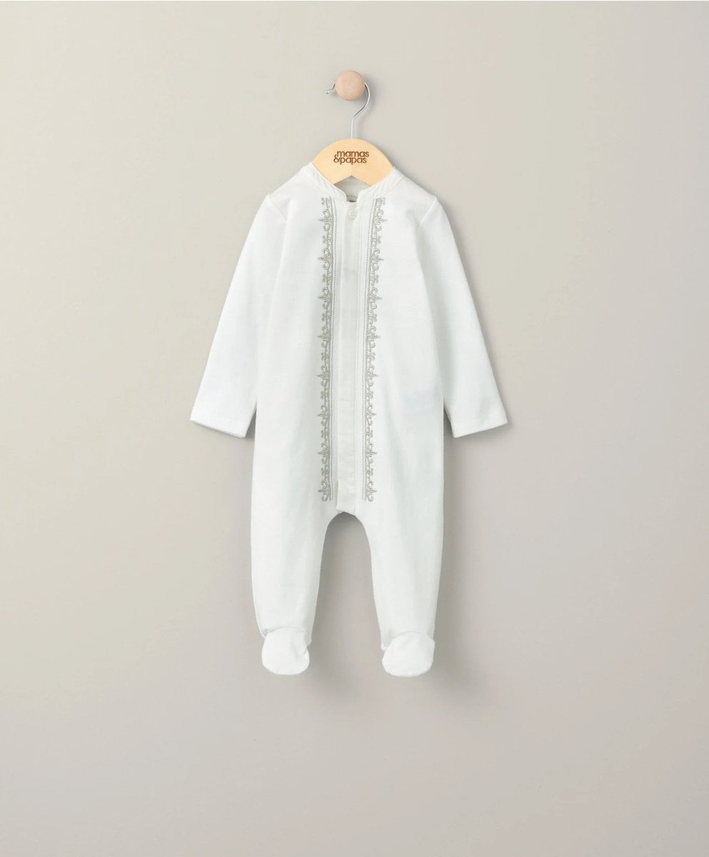 White embroidered sleepsuit with long sleeves and front opening, full-length legs.