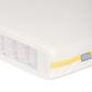 Cotbed mattress with white cover and yellow edge piping, side view