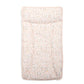 Changing mat mattress in light pink with repeating letter pattern, padded top.