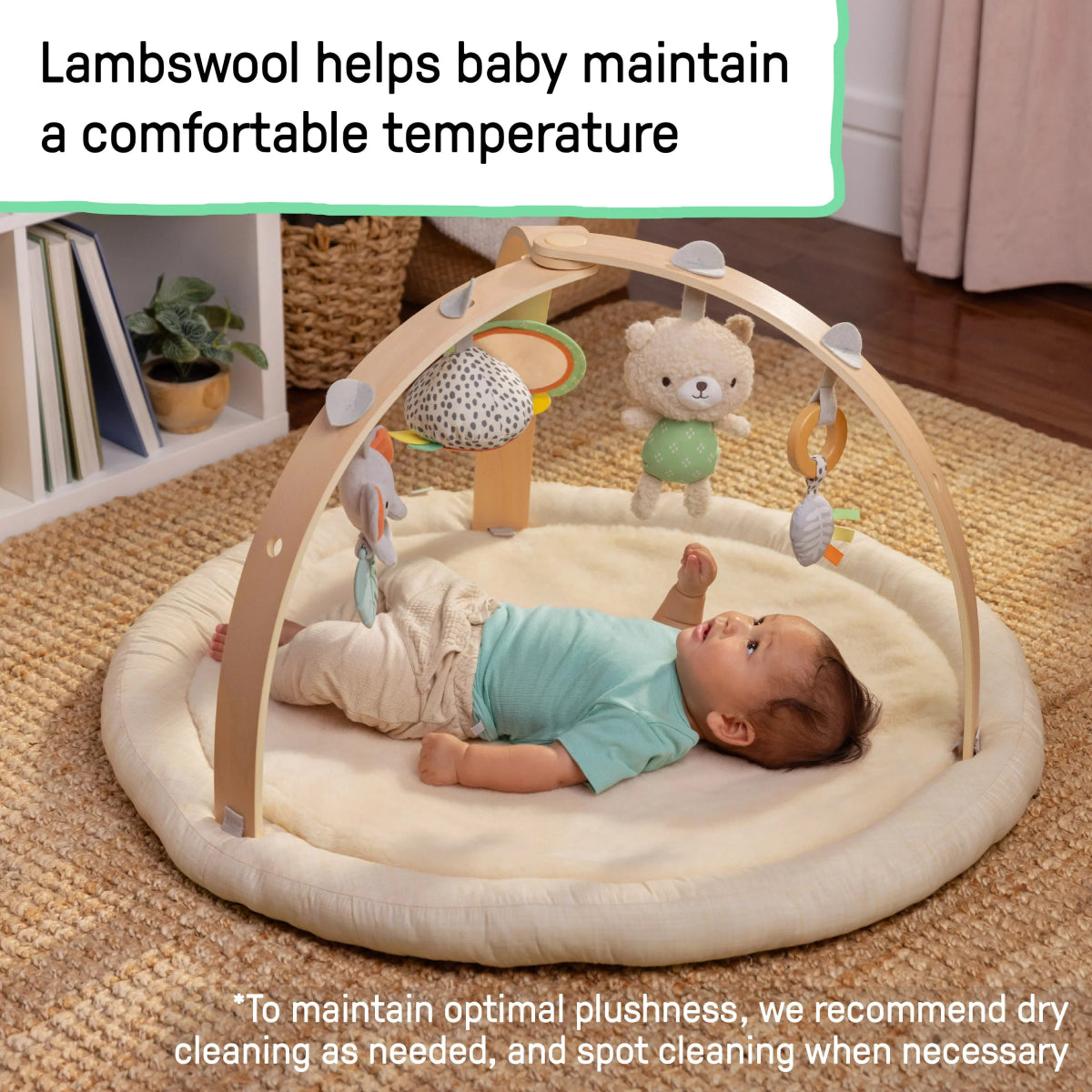 Natural plush lambswool baby play gym with arch toys and baby lying on mat
