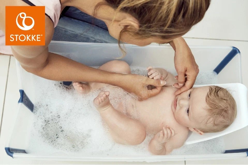 Flexi Bath® newborn support in white bath, baby being rinsed on contoured seat