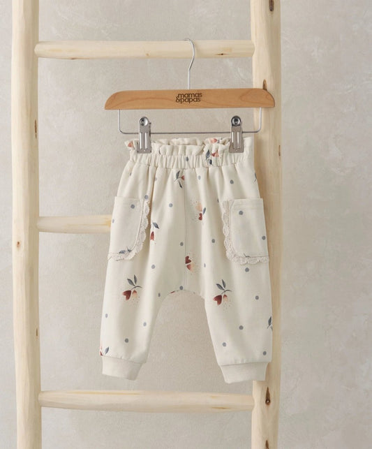 White floral heart joggers with elastic waistband and cuffed hems, side pockets