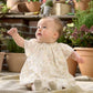 Baby in floral print dress with short sleeves and full skirt