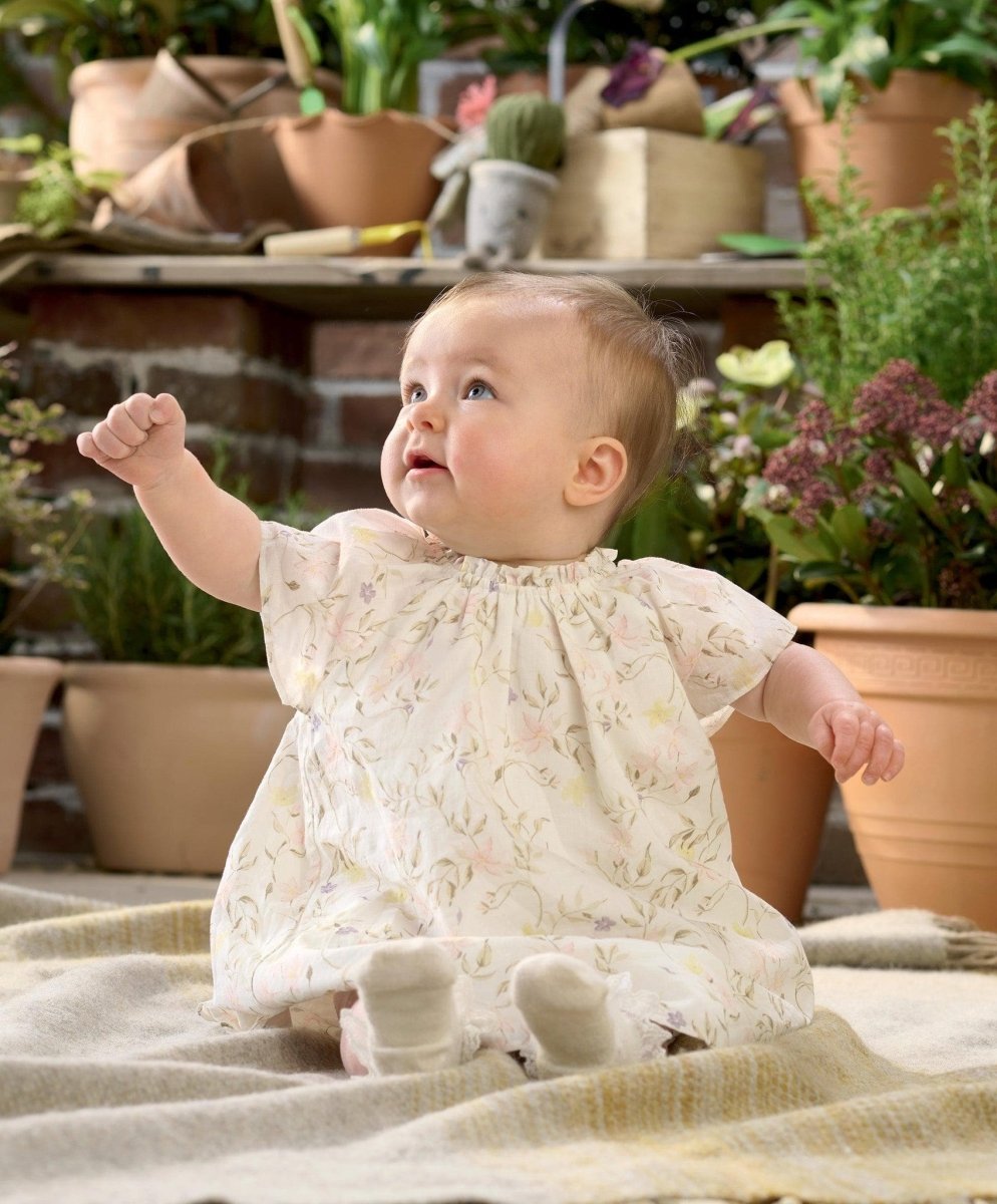 Baby in floral print dress with short sleeves and full skirt