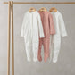 Set of three floral print sleepsuits, long-sleeve footed in white and blush pink