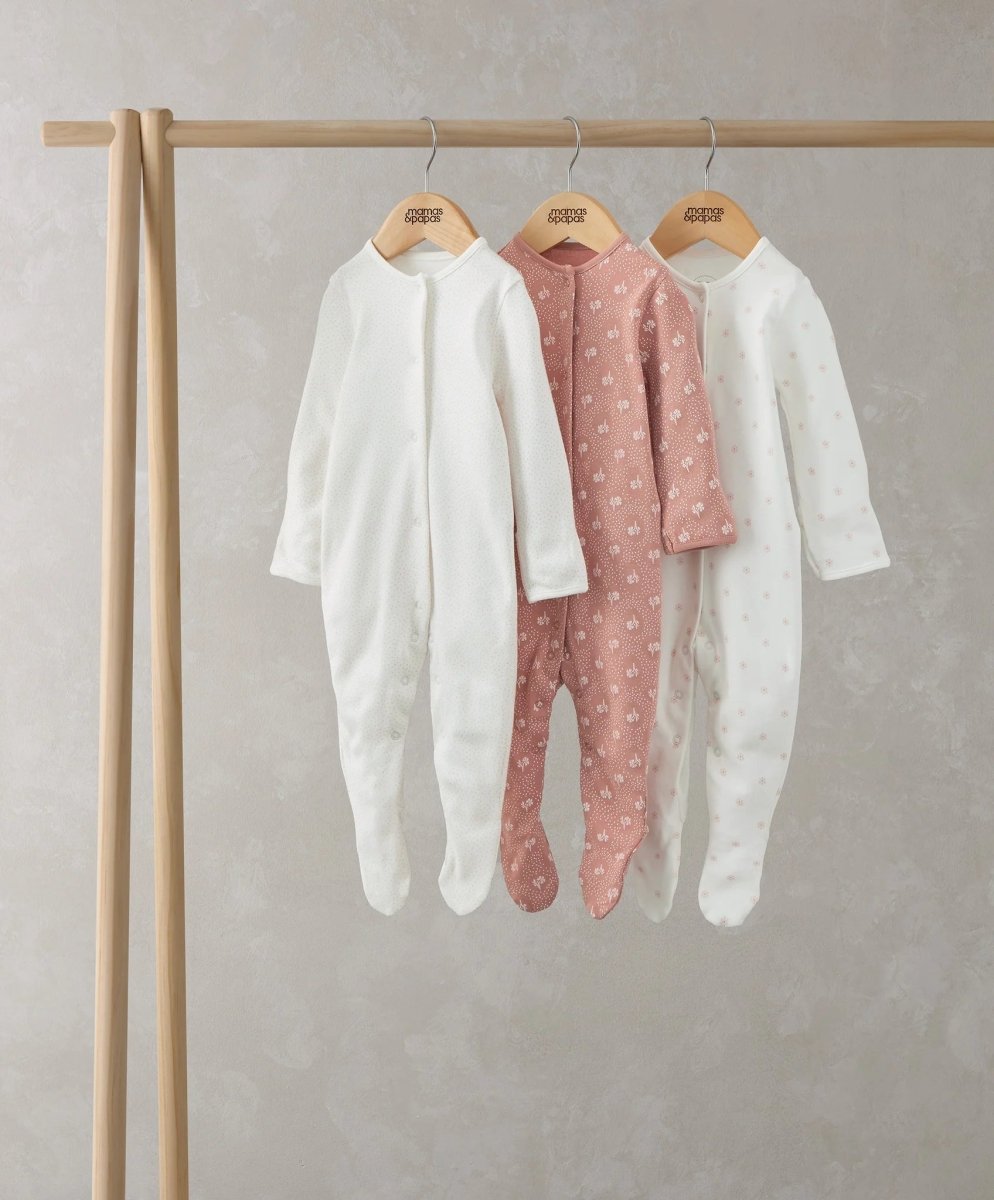 Set of three floral print sleepsuits, long-sleeve footed in white and blush pink