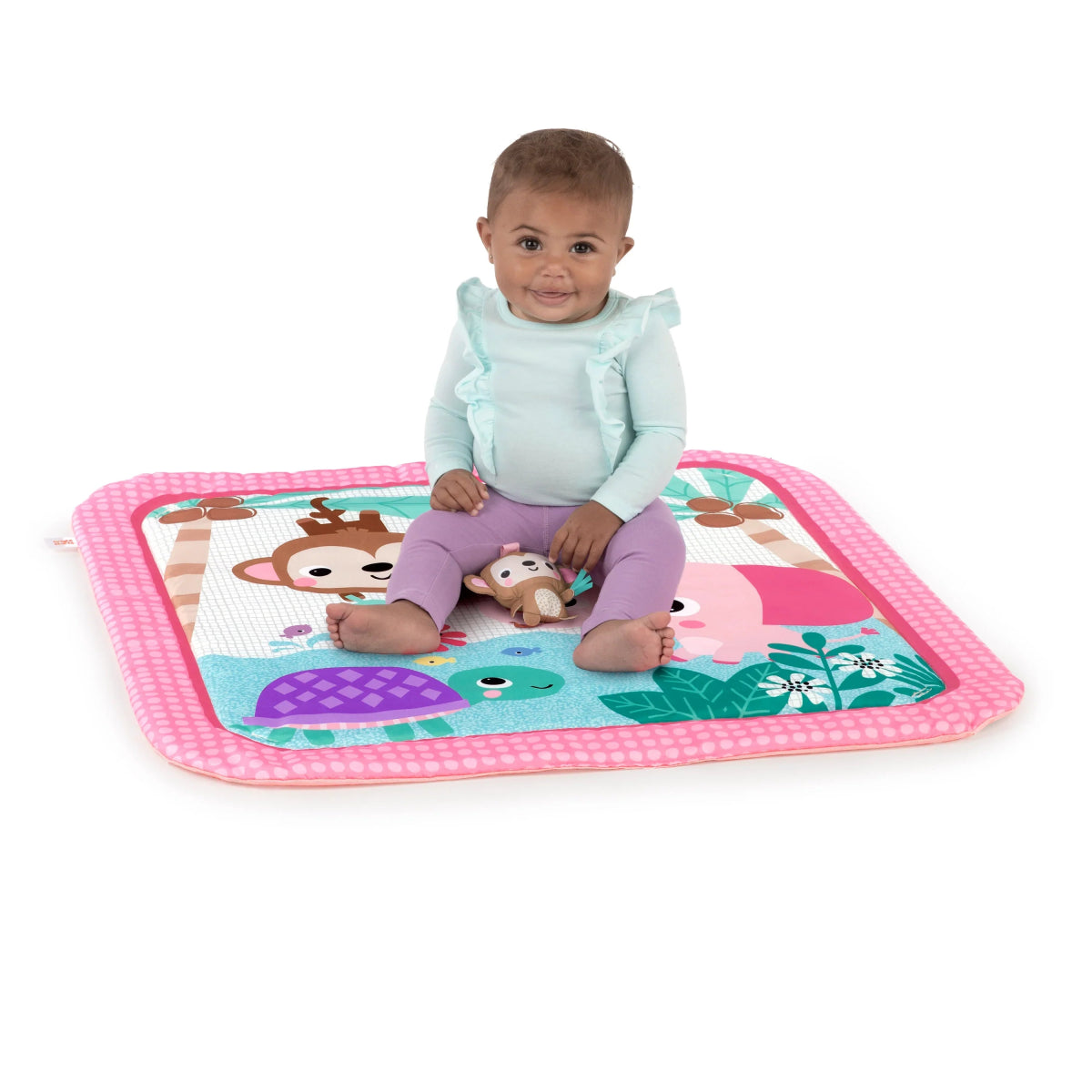 Safari activity gym with pink border and animal-theme play mat, child standing on top