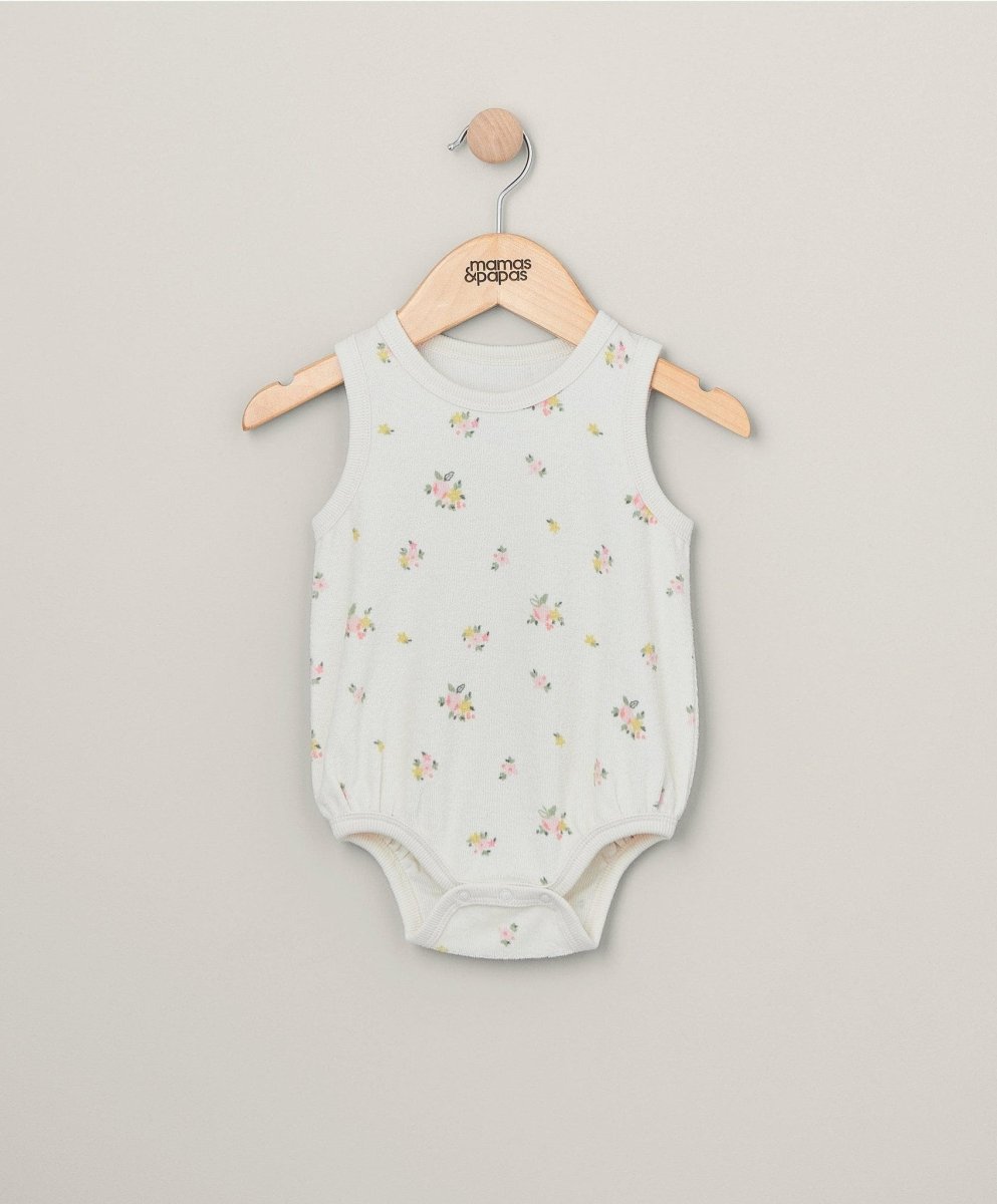 Light floral sleeveless towelling bodysuit on wooden hanger