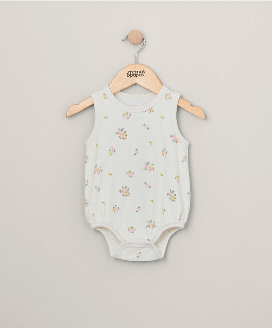 Light floral sleeveless towelling bodysuit on wooden hanger