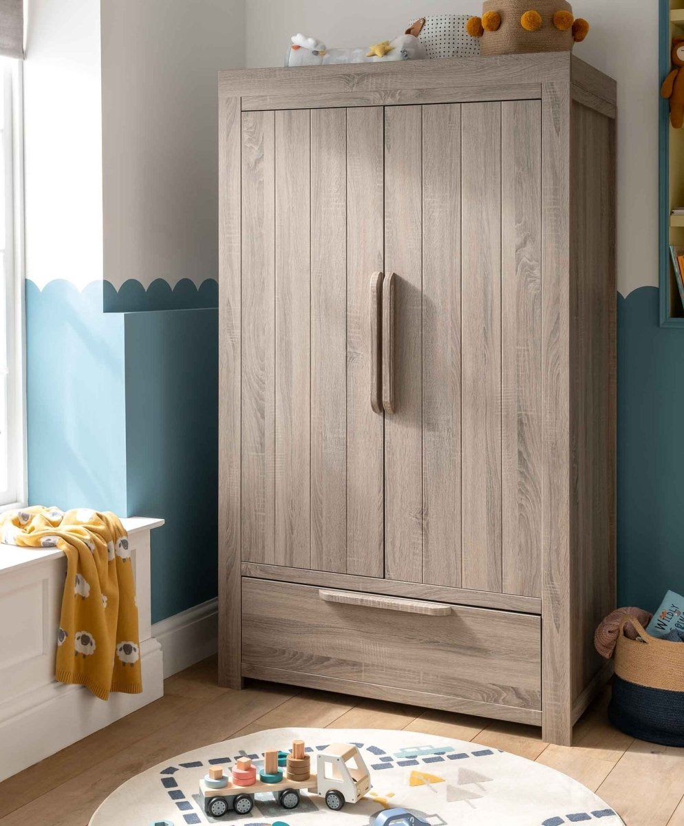 Grey wash 2-door nursery wardrobe with drawer and vertical handle, front view.