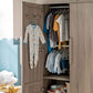 Open grey wash wardrobe with two doors, hanging clothes inside and shelves.