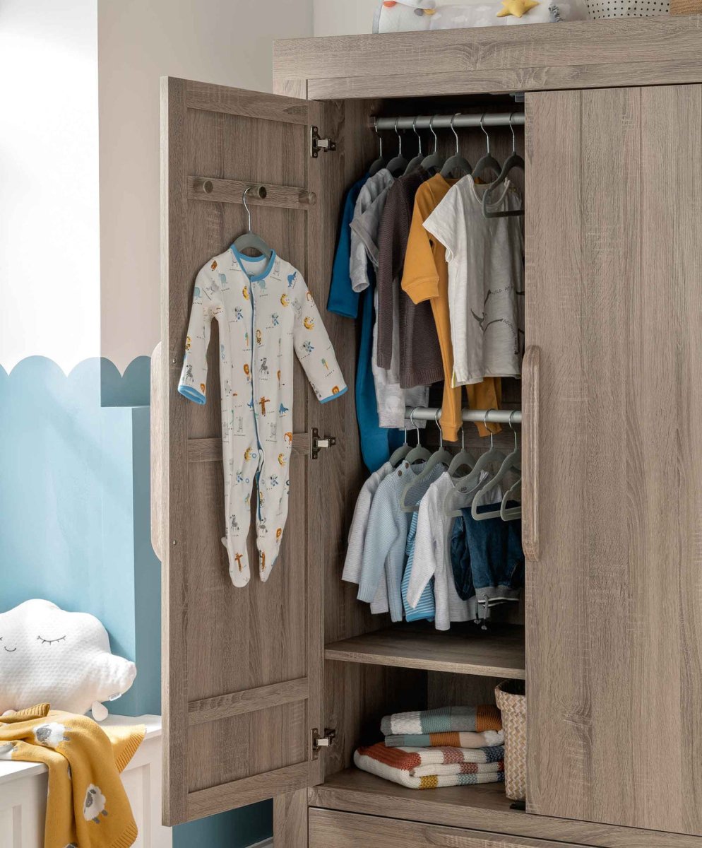 Open grey wash wardrobe with two doors, hanging clothes inside and shelves.