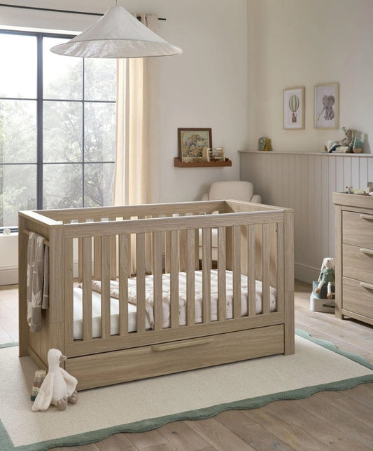 Oak cotbed with vertical slats and low front rail