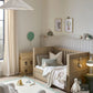 Oak cotbed with guard rails and slatted sides in nursery room