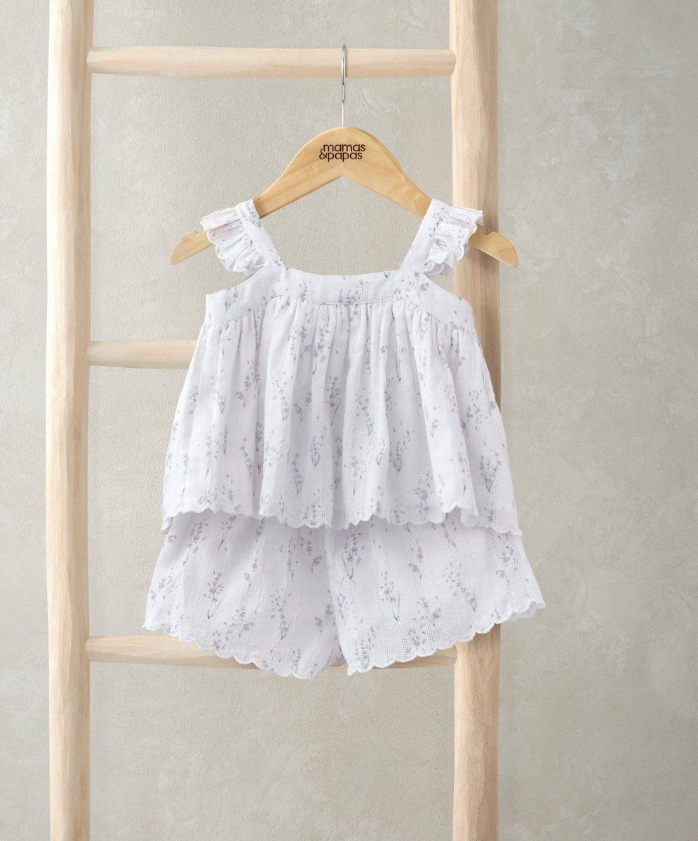 Frill-sleeve top and shorts set with ruffled tiers and lace edging, allover white print