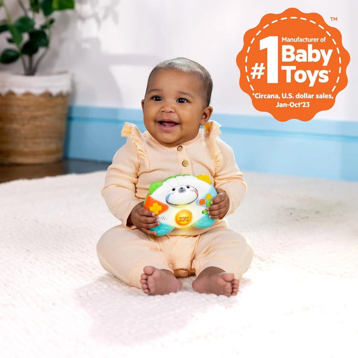 Baby holding a tiger-faced game controller toy with colorful buttons and lights