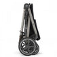 Black and grey stroller frame with large spoked wheels and folded canopy