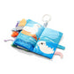 Sensory ocean book open with sea animal panels, handle loop, and attached plush toys