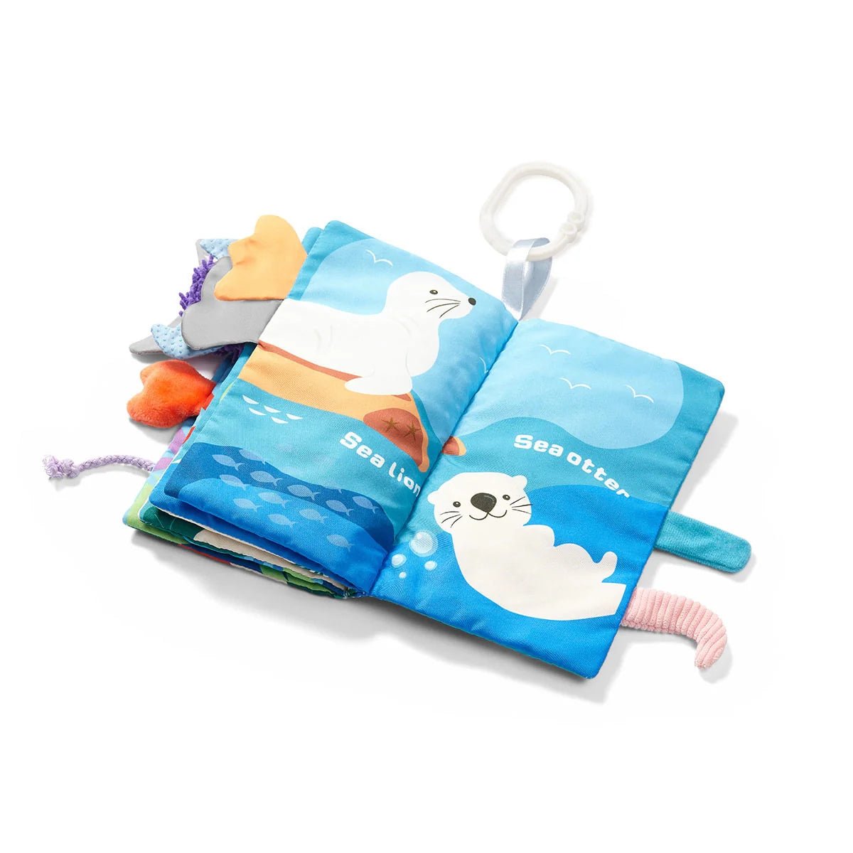Sensory ocean book open with sea animal panels, handle loop, and attached plush toys