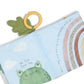 Soft fabric activity book open, showing frog and rainbow friend text