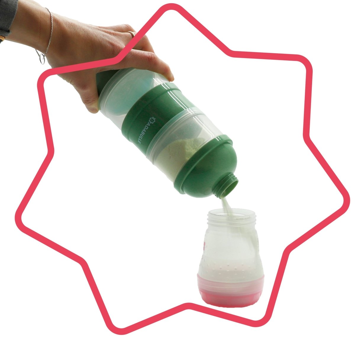 Green milk dispenser tilted by hand, pouring into a small bottle with red-ring base