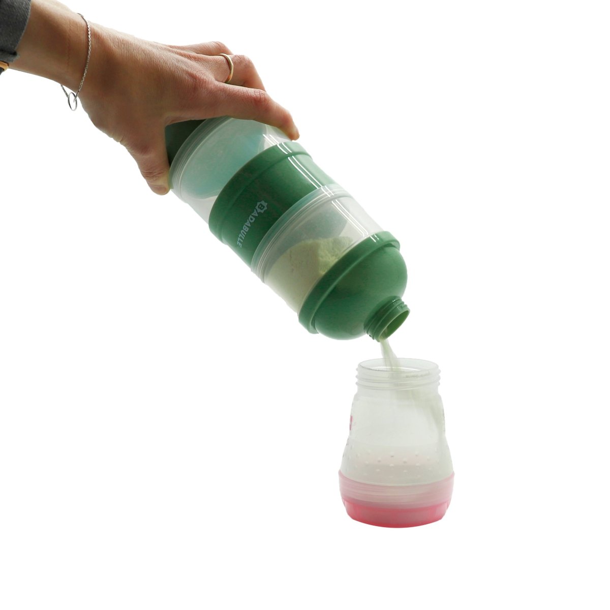 Green milk dispenser held above bottle, dispensing into a small bottle with seal cap