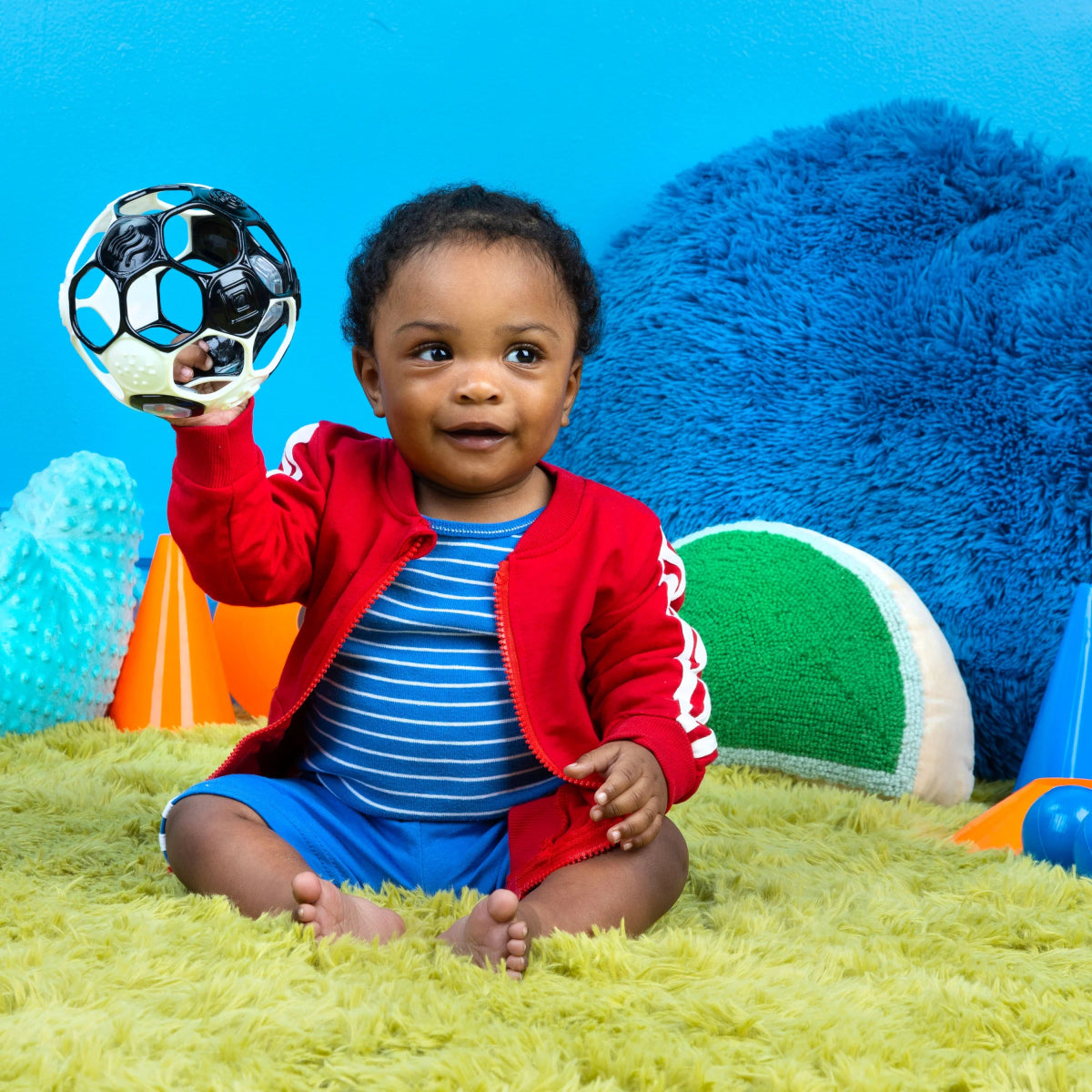 Black and white soccer rattle ball with colorful rattle window held up