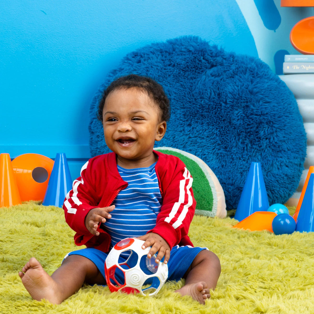 Red, white, and blue rattle soccer ball held by a child