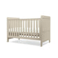 Cotbed in light grey with vertical slatted sides and panel headboard and footboard