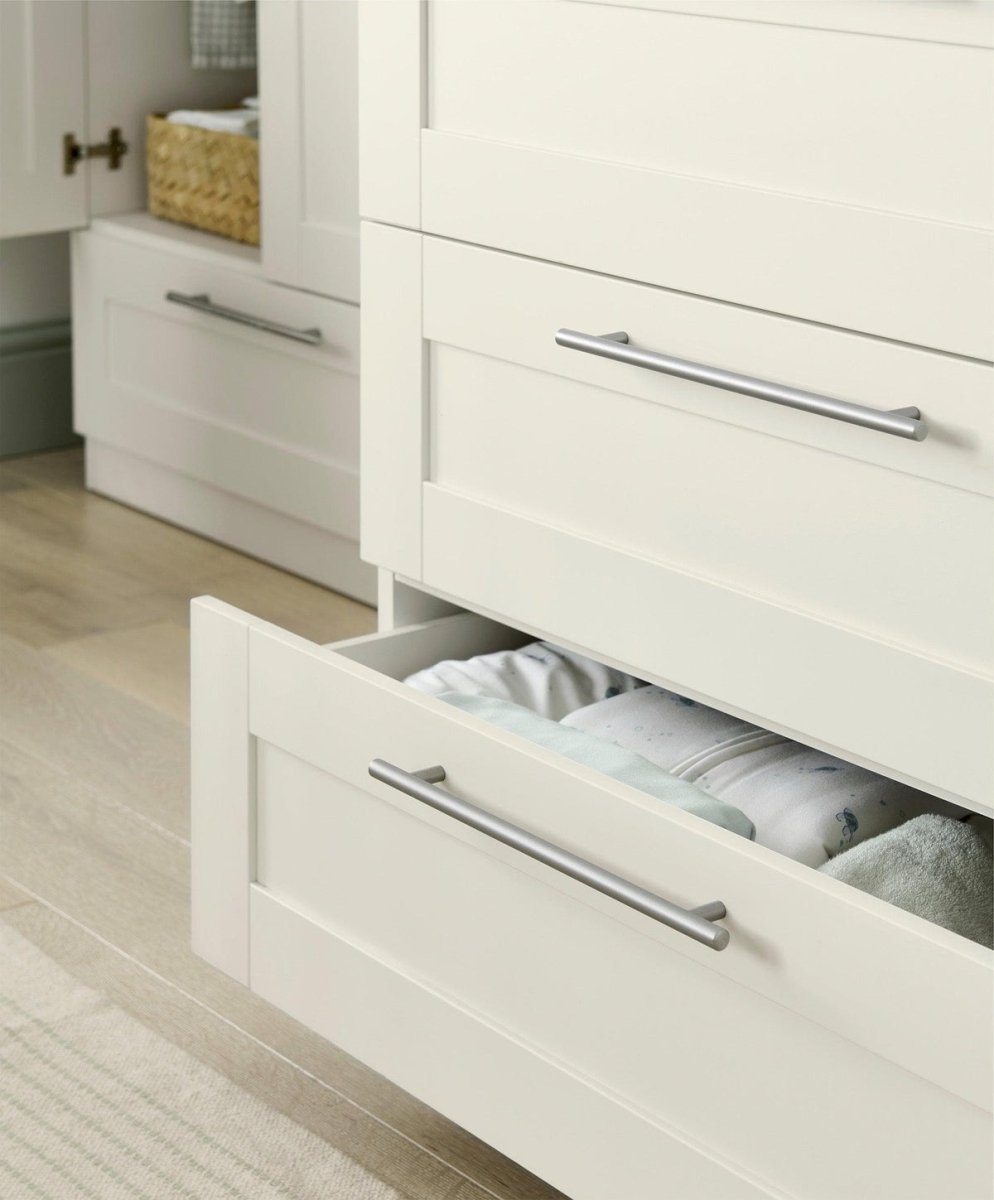 Dresser changer with open top drawer showing changing insert and metal bar pulls