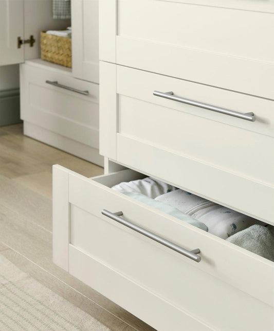 Dresser changer with open top drawer showing changing insert and metal bar pulls
