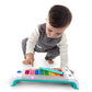Child playing Hape Magic Touch xylophone with multicolor keys and green mallet