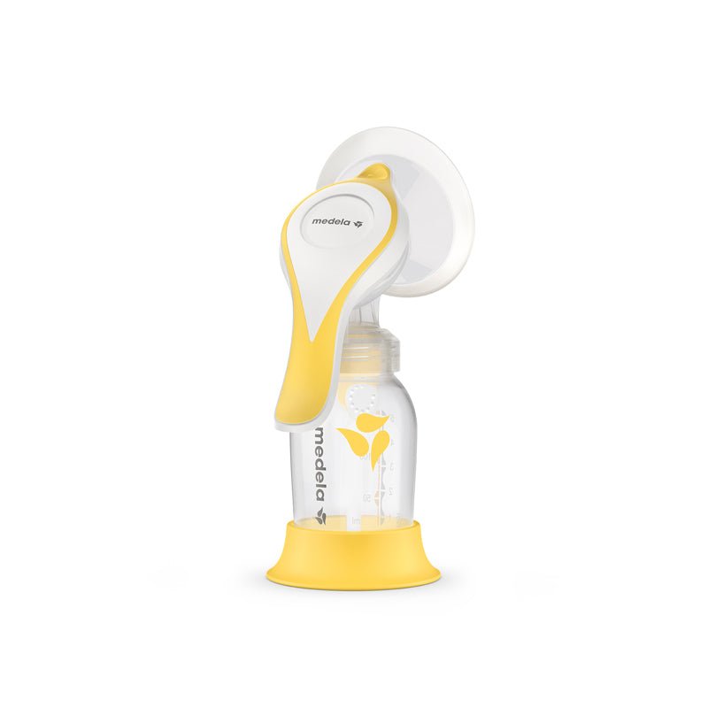 Manual breast pump with white flange, yellow handle, and clear bottle