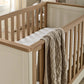 Harwell cotbed - cashmere close-up of wooden side rail with knit blanket