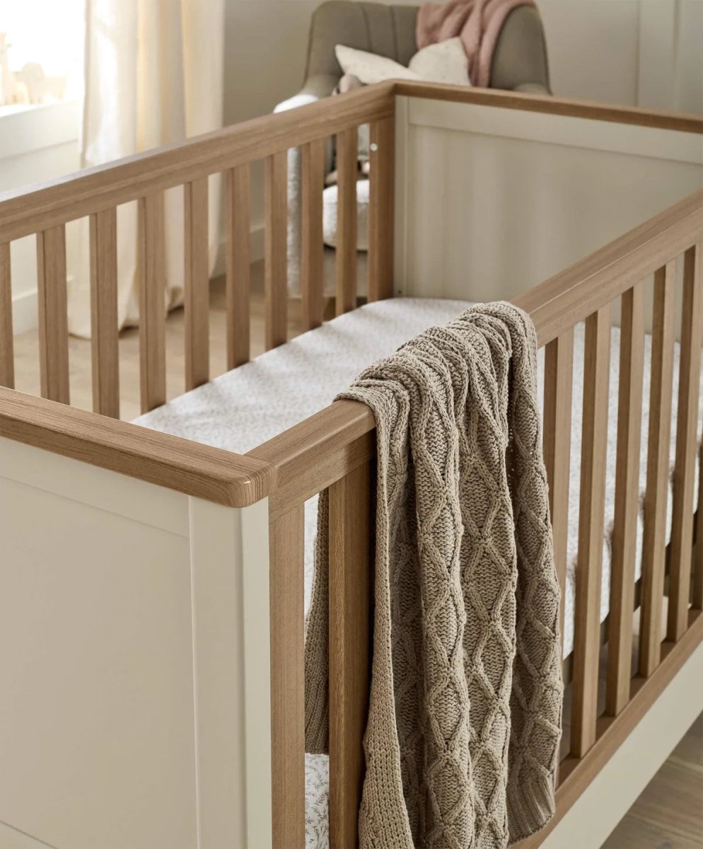 Harwell cotbed - cashmere close-up of wooden side rail with knit blanket