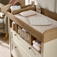 Baby dresser changer with cushioned changing surface and side rails, white drawers