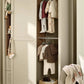 Wardrobe cabinet with open door showing hanging shirts and stacked folded knitwear