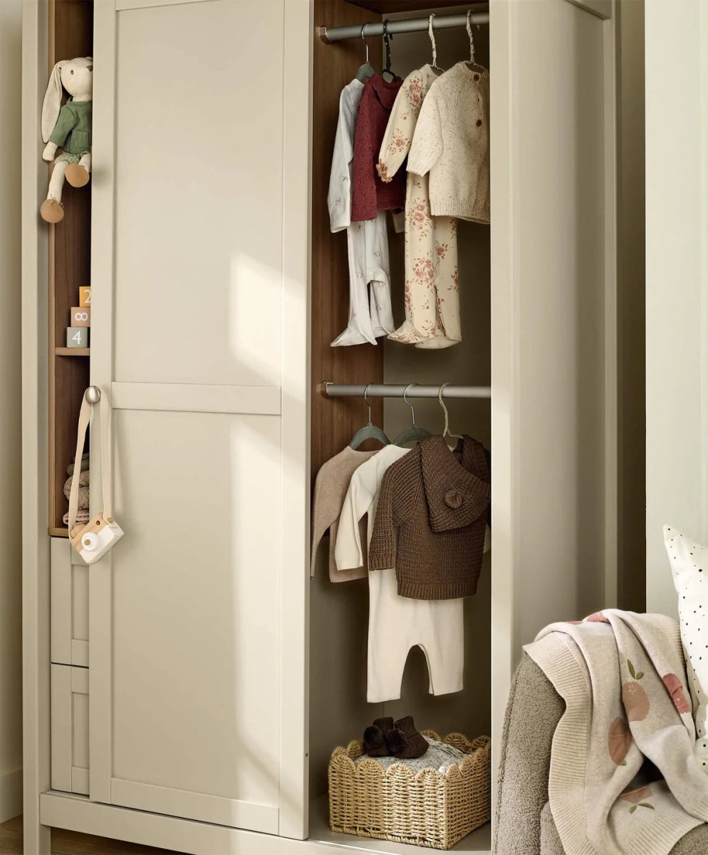Wardrobe cabinet with open door showing hanging shirts and stacked folded knitwear